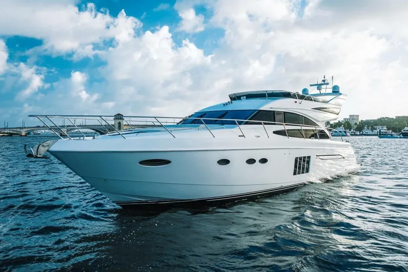 Aquavita Yacht Photos Pics Luxurious 2012 Princess 64 Flybridge Motor Yacht cruising on open water.