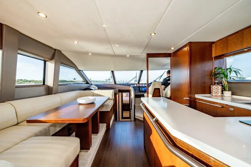 Aquavita Yacht Photos Pics Luxurious interior of 2012 Princess 64 Flybridge Motor Yacht with elegant wood finishes.