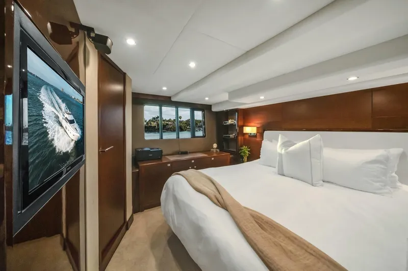 Aquavita Yacht Photos Pics Luxurious bedroom interior of 2012 Princess 64 Flybridge Motor Yacht with elegant wood finishes.