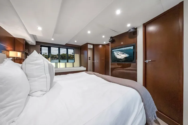 Aquavita Yacht Photos Pics Luxurious bedroom interior of 2012 Princess 64 Flybridge Motor Yacht with elegant wood finishes.