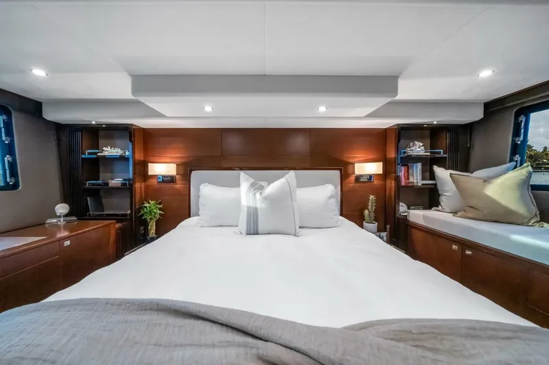 Aquavita Yacht Photos Pics Luxurious bedroom interior of 2012 Princess 64 Flybridge Motor Yacht with elegant wood finishes.