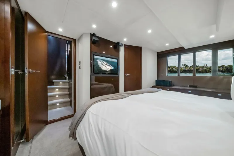 Aquavita Yacht Photos Pics Luxurious bedroom interior of 2012 Princess 64 Flybridge Motor Yacht with scenic window view.