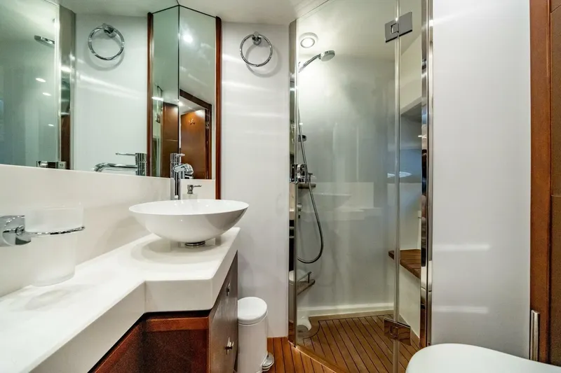 Aquavita Yacht Photos Pics Luxurious bathroom in 2012 Princess 64 Flybridge Motor Yacht with modern fixtures and glass shower.