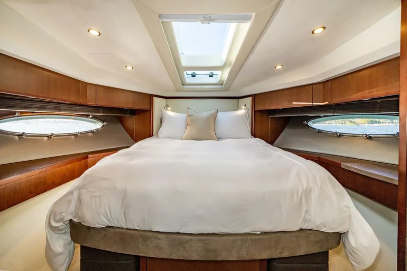 Aquavita Yacht Photos Pics Luxurious bedroom in 2012 Princess 64 Flybridge Motor Yacht with skylight and elegant wood finishes.