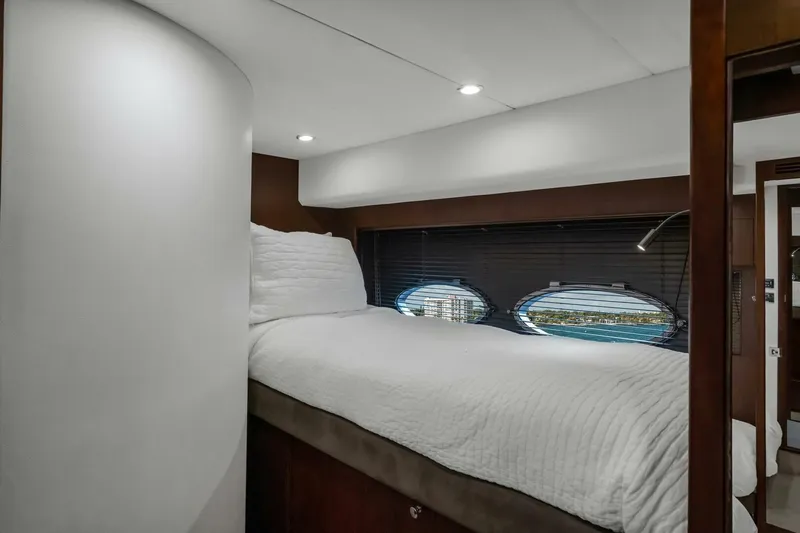 Aquavita Yacht Photos Pics Luxurious cabin interior of 2012 Princess 64 Flybridge Motor Yacht with porthole view.