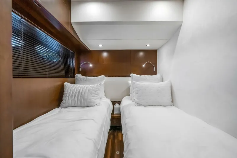 Aquavita Yacht Photos Pics Twin cabin interior of 2012 Princess 64 Flybridge Motor Yacht, featuring modern design and cozy bedding.