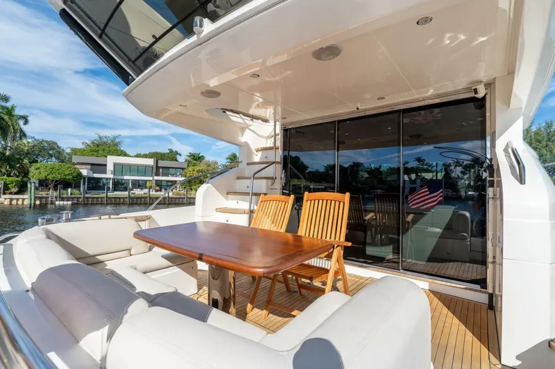 Aquavita Yacht Photos Pics Luxurious 2012 Princess 64 Flybridge Motor Yacht with elegant outdoor seating and dining area.