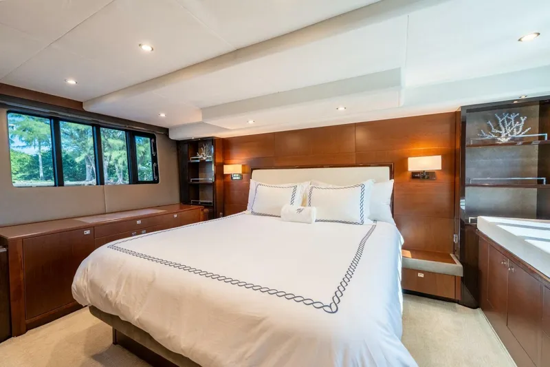 Aquavita Yacht Photos Pics Luxurious bedroom interior of 2012 Princess 64 Flybridge Motor Yacht with elegant wood finishes.