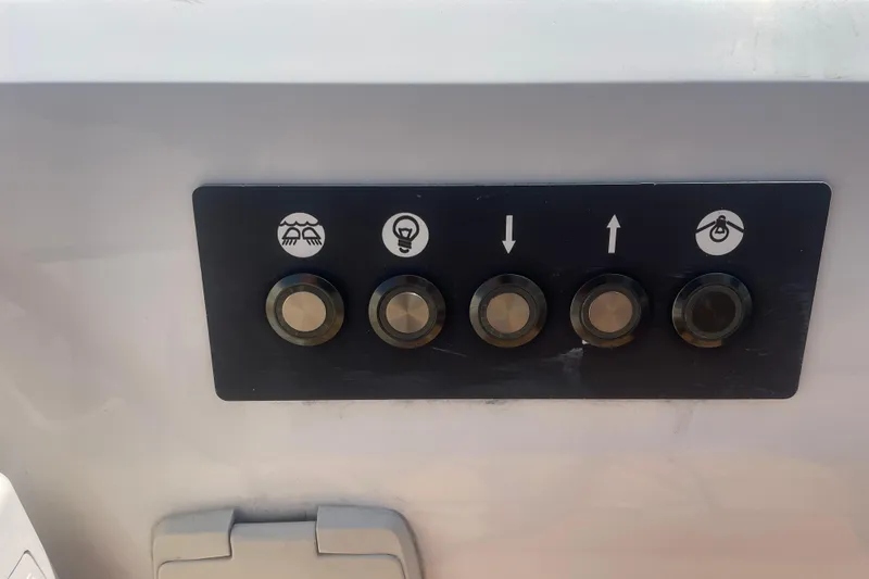 Dire Wolf Yacht Photos Pics Control panel with five buttons on a 2020 Beneteau Oceanis 46.1 yacht.