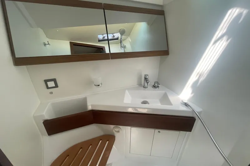 Dire Wolf Yacht Photos Pics Bathroom interior of 2020 Beneteau Oceanis 46.1 yacht, featuring modern sink and mirror.