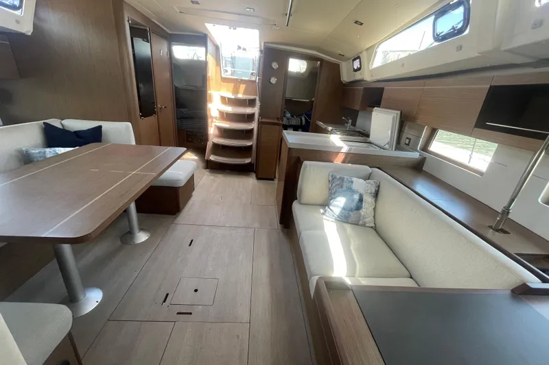 Dire Wolf Yacht Photos Pics Interior of 2020 Beneteau Oceanis 46.1 yacht, featuring modern wood finishes and spacious seating.