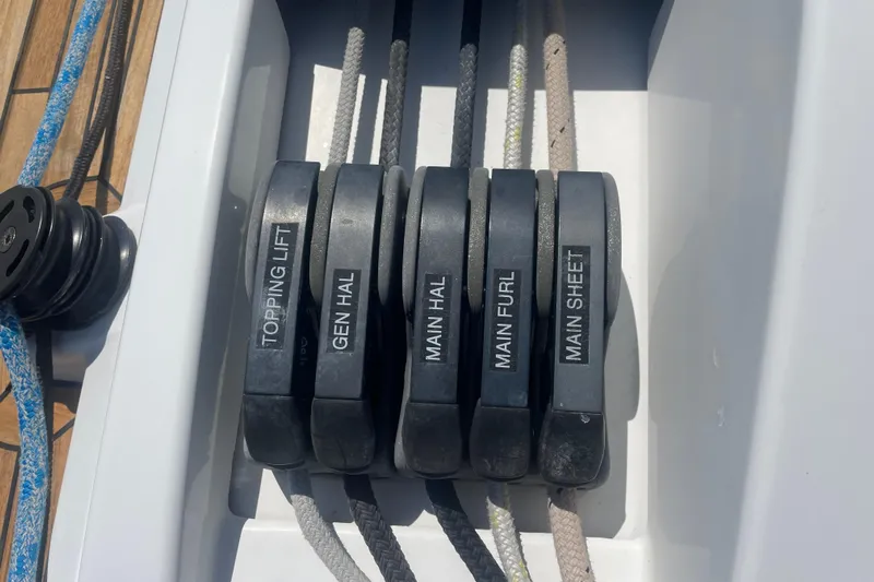 Dire Wolf Yacht Photos Pics Sailing controls on a 2020 Beneteau Oceanis 46.1 yacht, featuring labeled ropes and pulleys.