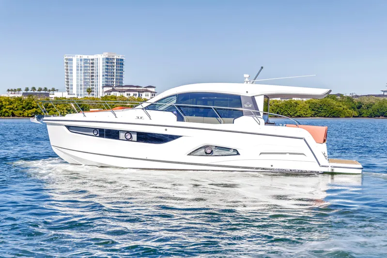  Yacht Photos Pics 2020 Sealine C390 yacht cruising on a sunny day near modern buildings.