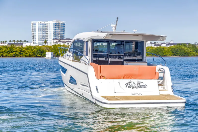  Yacht Photos Pics 2020 Sealine C390 yacht cruising in Tampa Bay, Florida, with modern waterfront buildings.