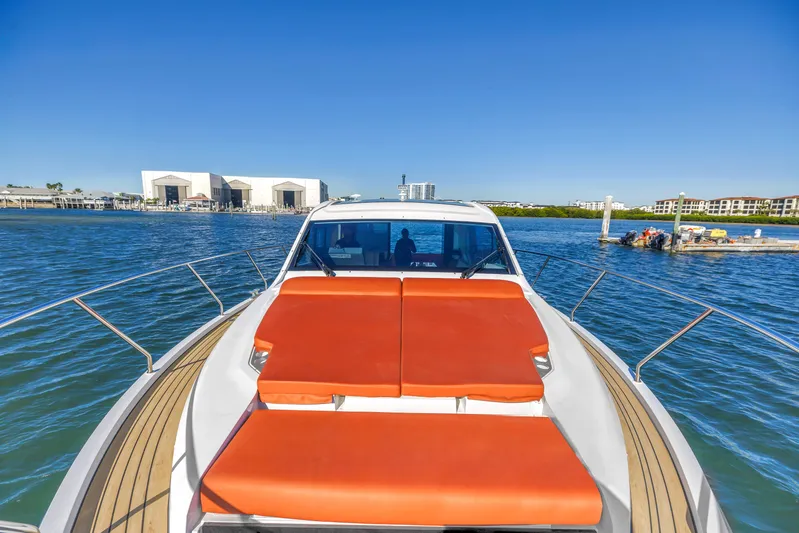  Yacht Photos Pics 2020 Sealine C390 yacht with orange sunbeds on deck, docked in a marina.