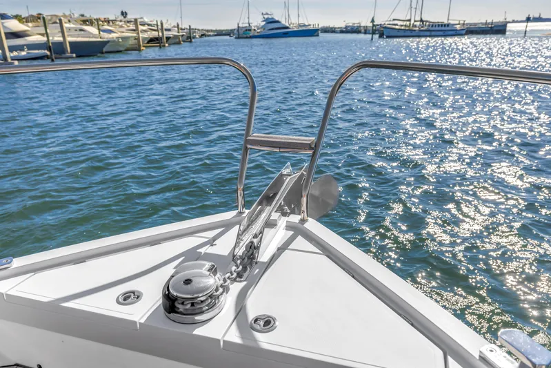  Yacht Photos Pics Bow view of 2020 Sealine C390 yacht on sparkling water, with marina in background.