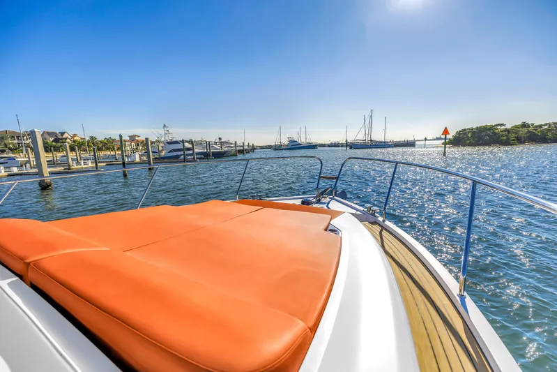  Yacht Photos Pics 2020 Sealine C390 yacht with orange sunbed, docked in a sunny marina.