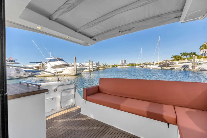  Yacht Photos Pics 2020 Sealine C390 yacht interior with marina view, featuring a comfortable seating area.