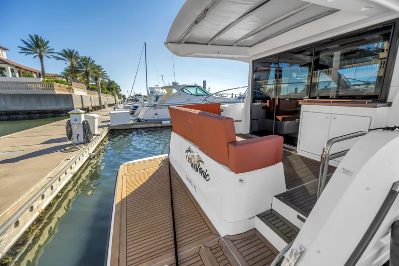  Yacht Photos Pics 2020 Sealine C390 yacht docked at marina with palm trees and clear sky.