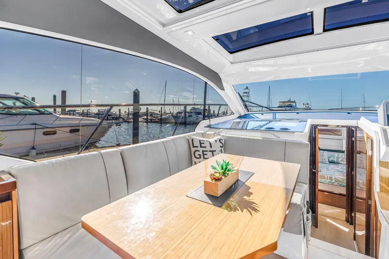  Yacht Photos Pics Interior of 2020 Sealine C390 yacht with dining area and marina view.