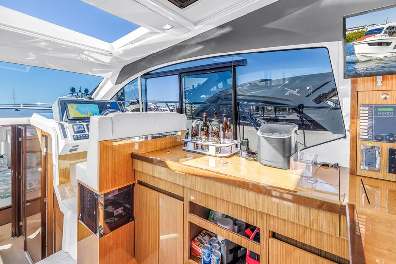  Yacht Photos Pics Luxurious interior of 2020 Sealine C390 yacht with modern navigation and bar area.