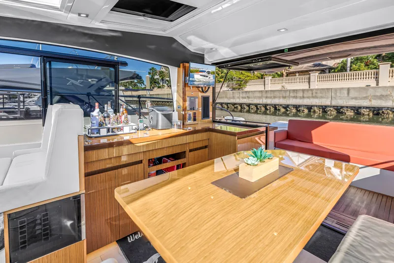  Yacht Photos Pics Luxurious interior of 2020 Sealine C390 yacht with modern seating and elegant wooden table.