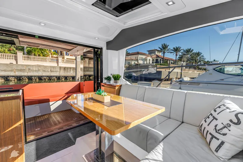  Yacht Photos Pics Luxurious interior of 2020 Sealine C390 yacht with elegant seating and waterfront view.