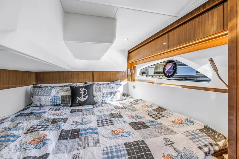  Yacht Photos Pics Luxurious cabin interior of 2020 Sealine C390 yacht with nautical-themed bedding.
