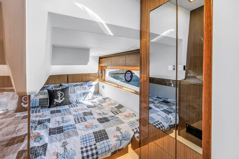  Yacht Photos Pics Luxurious cabin interior of 2020 Sealine C390 yacht with nautical-themed bedding.