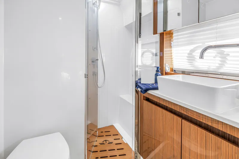  Yacht Photos Pics Luxurious bathroom in 2020 Sealine C390 yacht with modern fixtures and wooden accents.