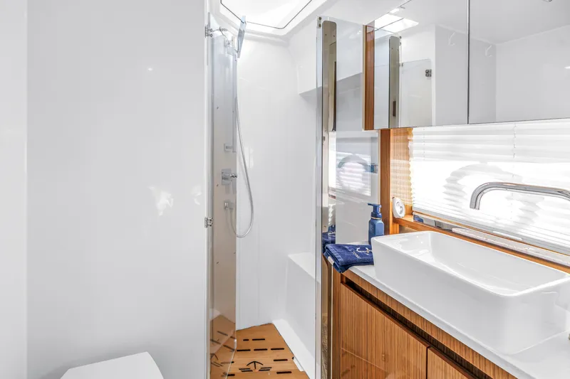  Yacht Photos Pics Modern bathroom in 2020 Sealine C390 yacht with sleek fixtures and wooden accents.