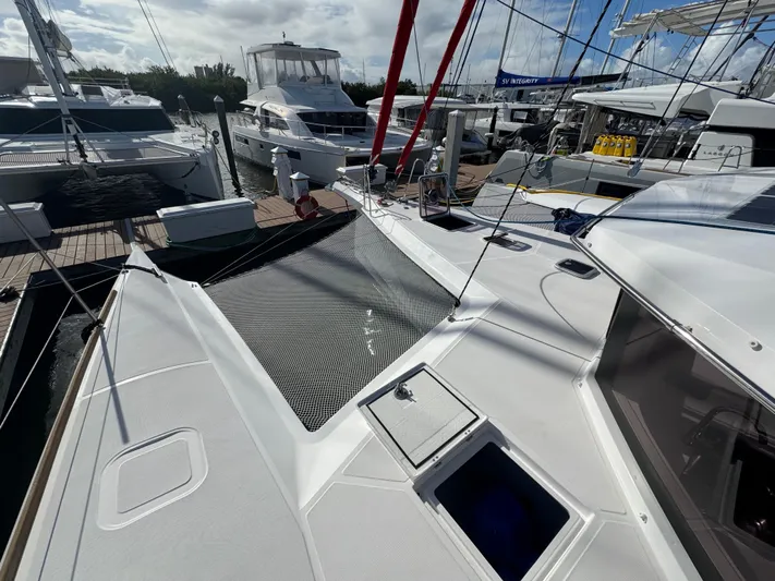 Encantado Yacht Photos Pics 2023 NEEL 47 trimaran docked at marina with other boats.