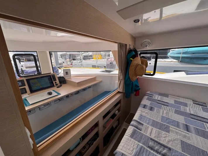 Encantado Yacht Photos Pics Interior of 2023 NEEL 47 trimaran with cozy cabin and navigation station.