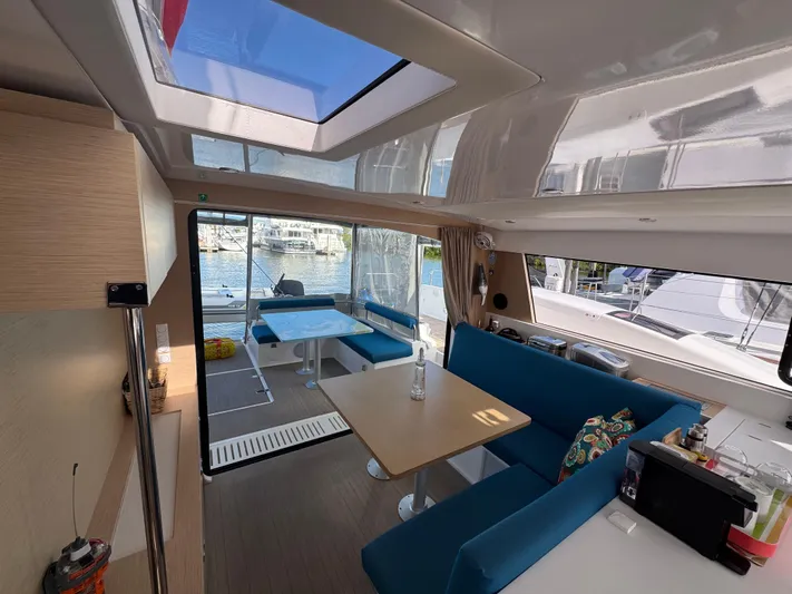 Encantado Yacht Photos Pics Interior of 2023 NEEL 47 catamaran with modern seating and skylight.