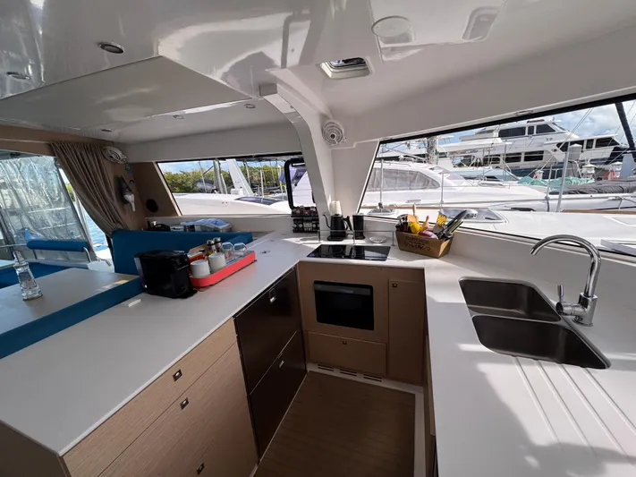 Encantado Yacht Photos Pics Modern NEEL 47 yacht kitchen interior with sleek countertops and appliances, 2023 model.