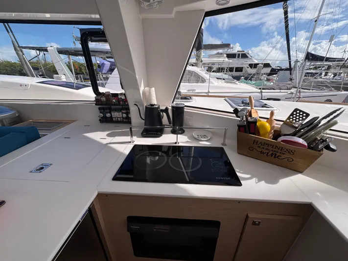 Encantado Yacht Photos Pics Modern kitchen on NEEL 47 yacht, featuring sleek appliances and marina view.
