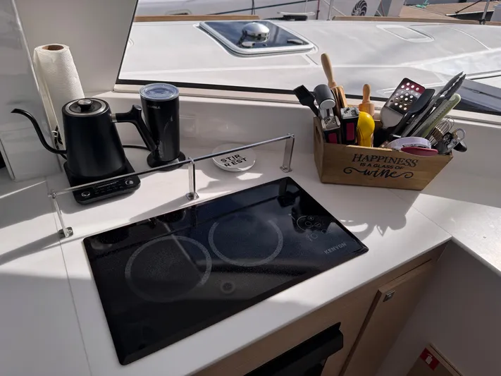 Encantado Yacht Photos Pics Modern NEEL 47 yacht kitchen with induction cooktop and utensils, 2023 model.