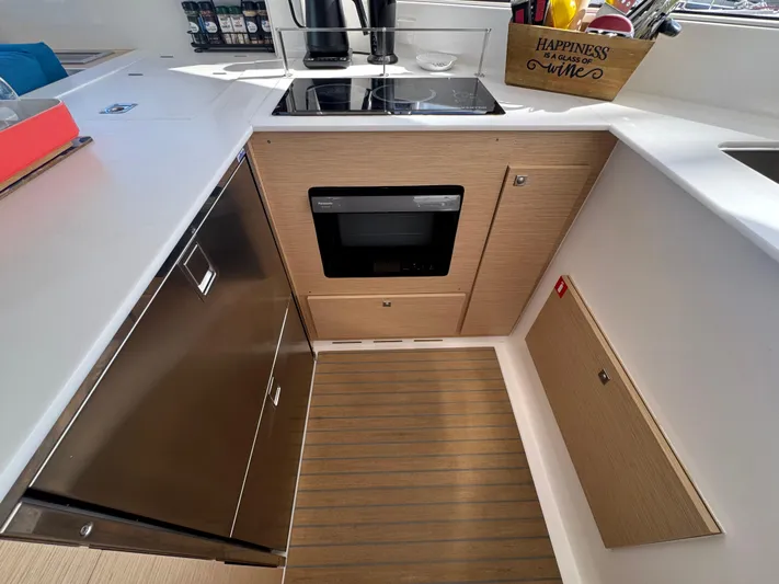 Encantado Yacht Photos Pics Modern kitchen in 2023 NEEL 47 yacht with sleek appliances and wooden cabinetry.