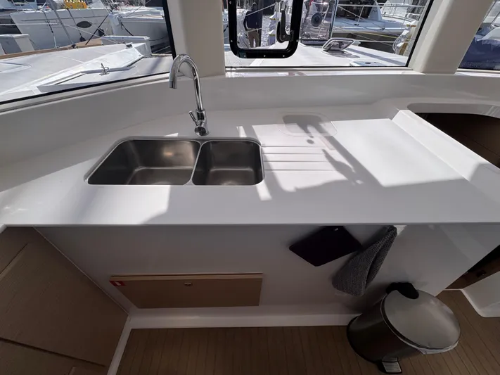 Encantado Yacht Photos Pics Modern kitchen area on NEEL 47 yacht, featuring a double sink and sleek countertop.