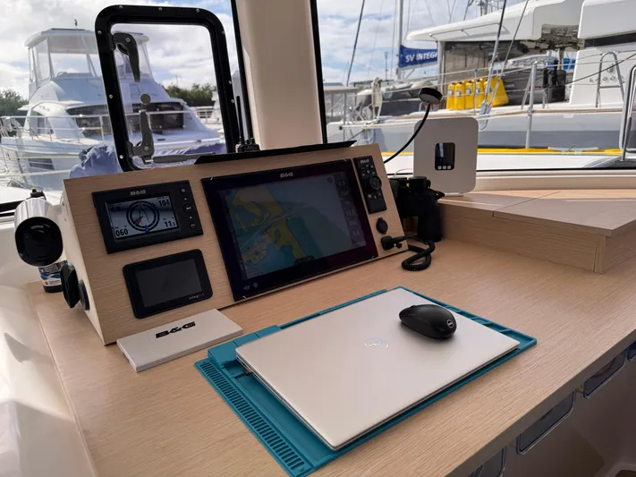 Encantado Yacht Photos Pics Navigation station on 2023 NEEL 47 trimaran with modern equipment and laptop.