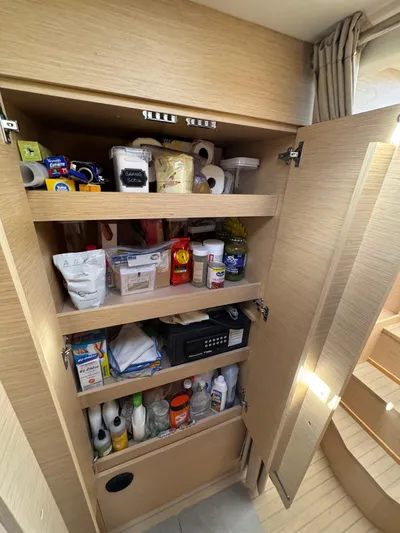 Encantado Yacht Photos Pics Pantry storage in NEEL 47 yacht, 2023 model, with shelves of food and supplies.