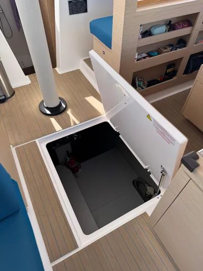 Encantado Yacht Photos Pics Open hatch on NEEL 47 trimaran, showcasing interior storage space, 2023 model.