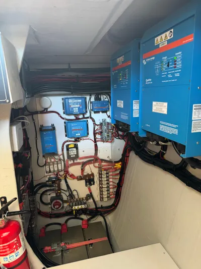 Encantado Yacht Photos Pics Electrical system setup in a 2023 NEEL 47 boat, featuring blue control panels and wiring.
