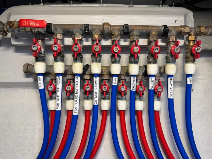 Encantado Yacht Photos Pics Plumbing system with labeled valves and colored pipes on a 2023 NEEL 47 model.