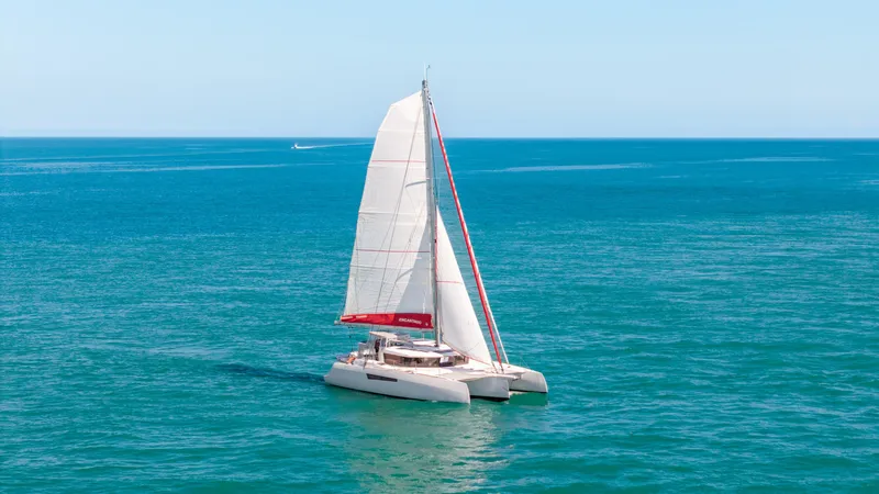 Encantado Yacht Photos Pics 2023 NEEL 47 trimaran sailing on open blue sea.