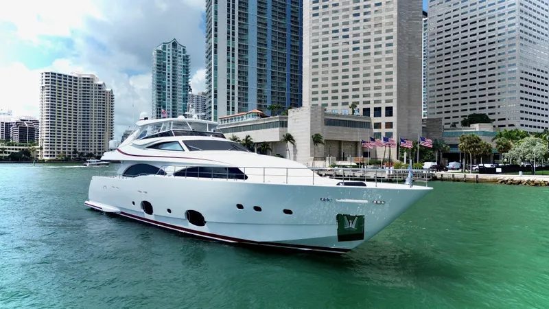  Yacht Photos Pics Luxurious 2016 Custom Line 97 yacht cruising in a city harbor with skyscrapers.