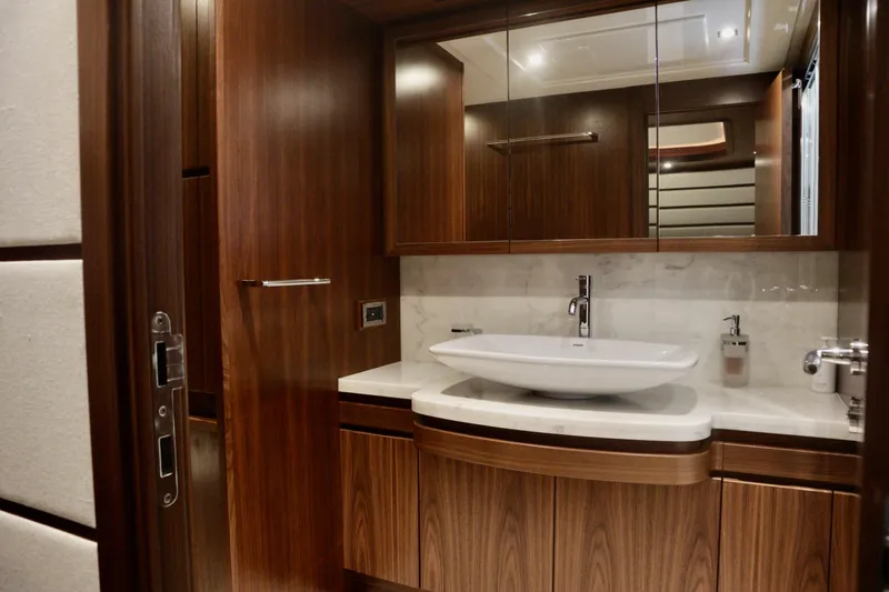  Yacht Photos Pics Luxurious bathroom interior on 2016 Custom Line 97 yacht with elegant wood finish.