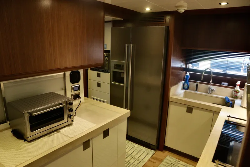  Yacht Photos Pics Luxurious kitchen interior of 2016 Custom Line 97 yacht with modern appliances.