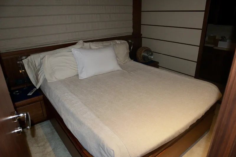  Yacht Photos Pics Luxurious bedroom interior on a 2016 Custom Line 97 yacht, featuring a neatly made bed.