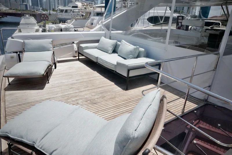  Yacht Photos Pics Luxurious 2016 Custom Line 97 yacht deck with elegant seating and scenic marina view.